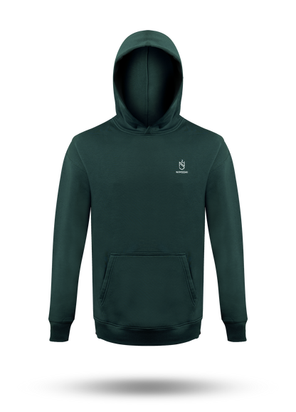 A nimsdai store relentless dark forest green pullover hoodie with a small white embroidered crest logo on the left chest, displayed on a clean white background with a soft drop shadow.